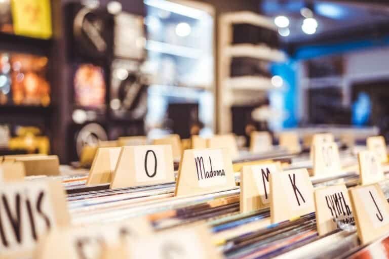 Why Vinyl Refuses to Die: Record Culture, Ritual & Community 4 Vintage vinyl records organized by artist and album in a record store.